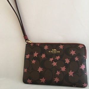 Coach Corner Zip Wristlet in Signature Canvas.